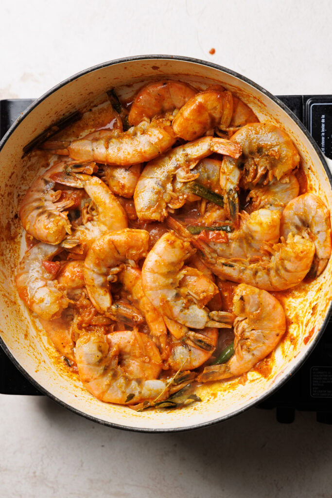 cooking prawns halfway in the pan.