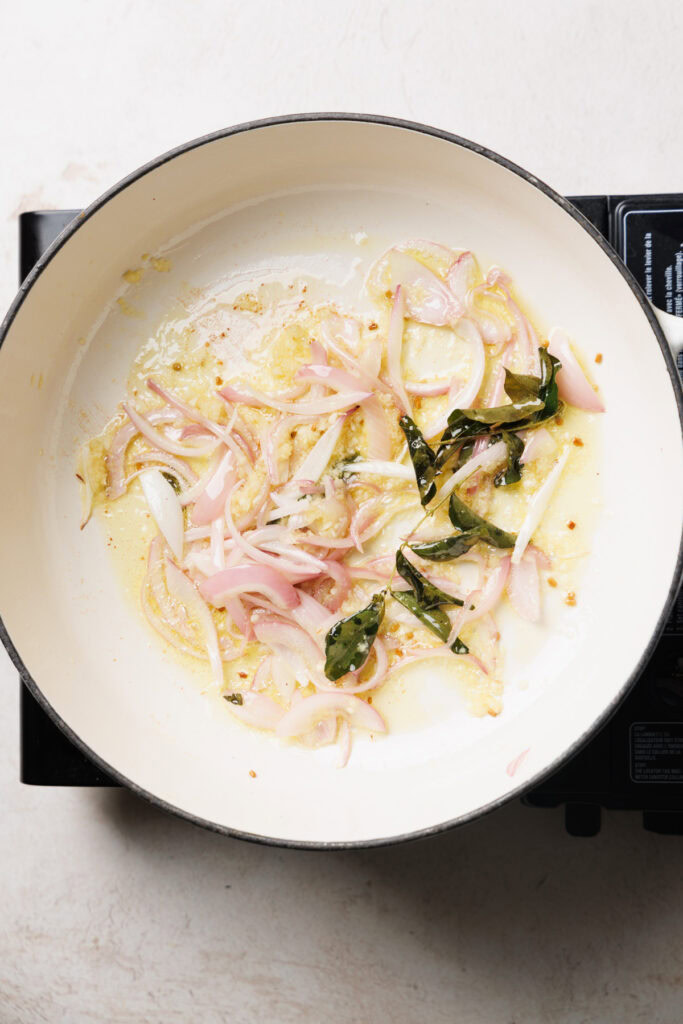 aromatics and onion sizziling in oil in a pan.