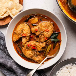 Spicy Sri Lankan fish curry in a bowl with spoon.
