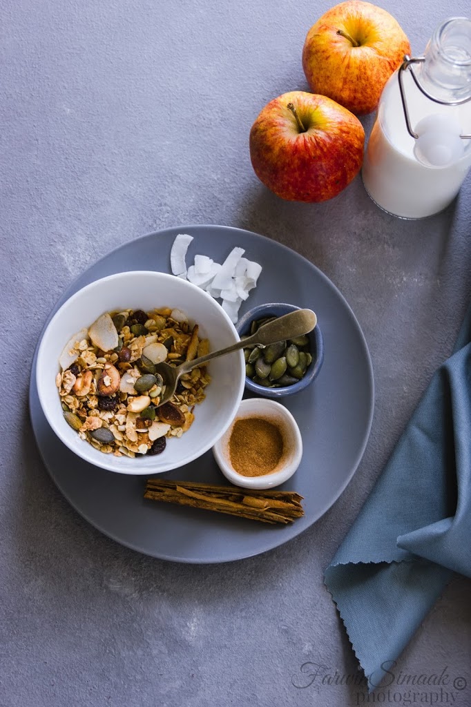 cinnamon coconut granola on a bowl in a blue background.