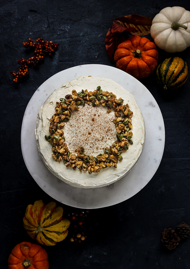 GF pumpkin layer cake with cream cheese frosting with walnut and pumkin seed topping