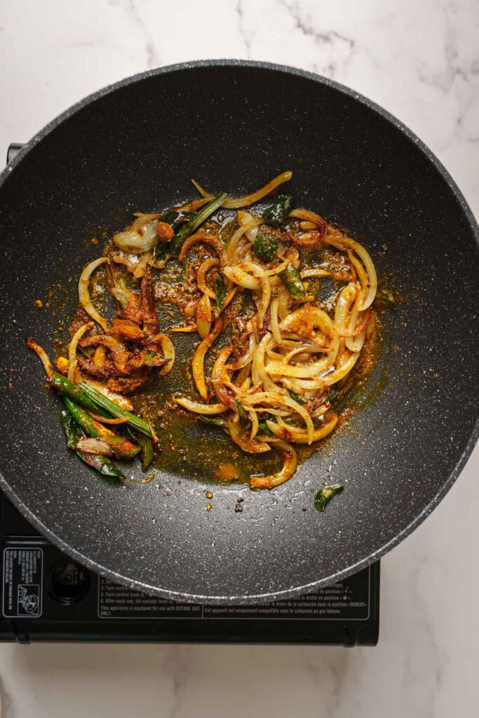 adding the spices and sauteing in the pot.