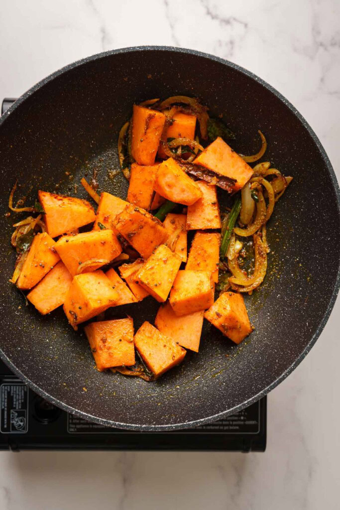 adding the pumpkin pieces to the pot.