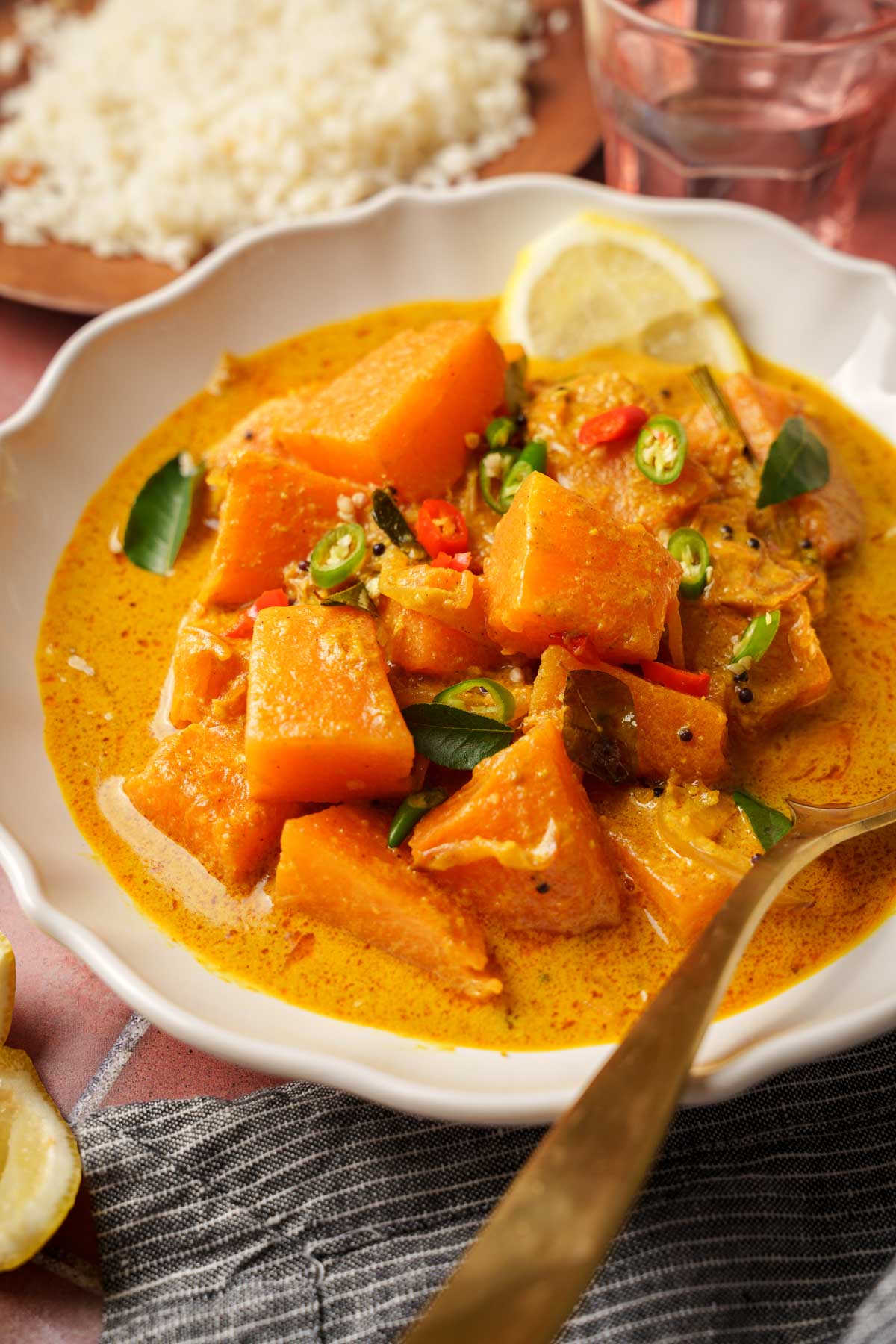 sri lankan pumpkin curry in a bowl with a spoon.