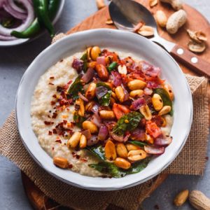 indian savory oatmeal bowl with peanuts, onions, chili and spices