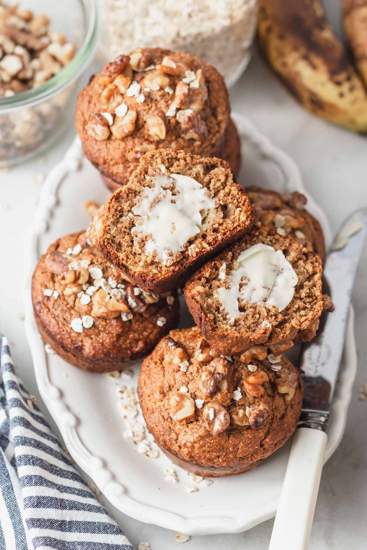 lactation muffins sliced and buttered on a plate.