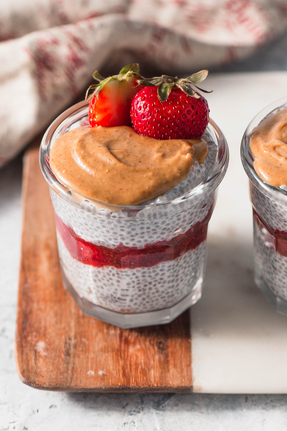 Keto chia pudding served in a jar with peanut butter and strawberry jam
