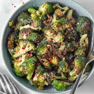 air fryer crispy broccoli in a bowl with chili flakes and parmesan
