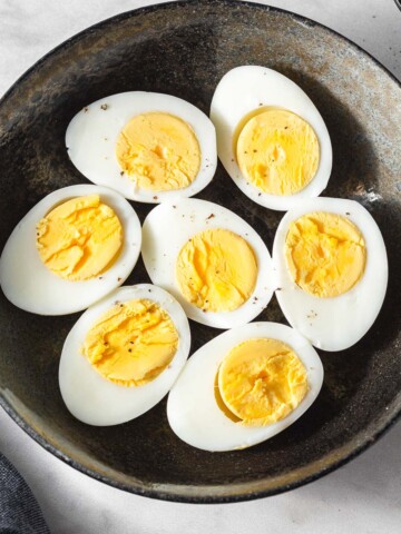 instant pot hard boiled eggs on a plate with a sprinkle of black pepper