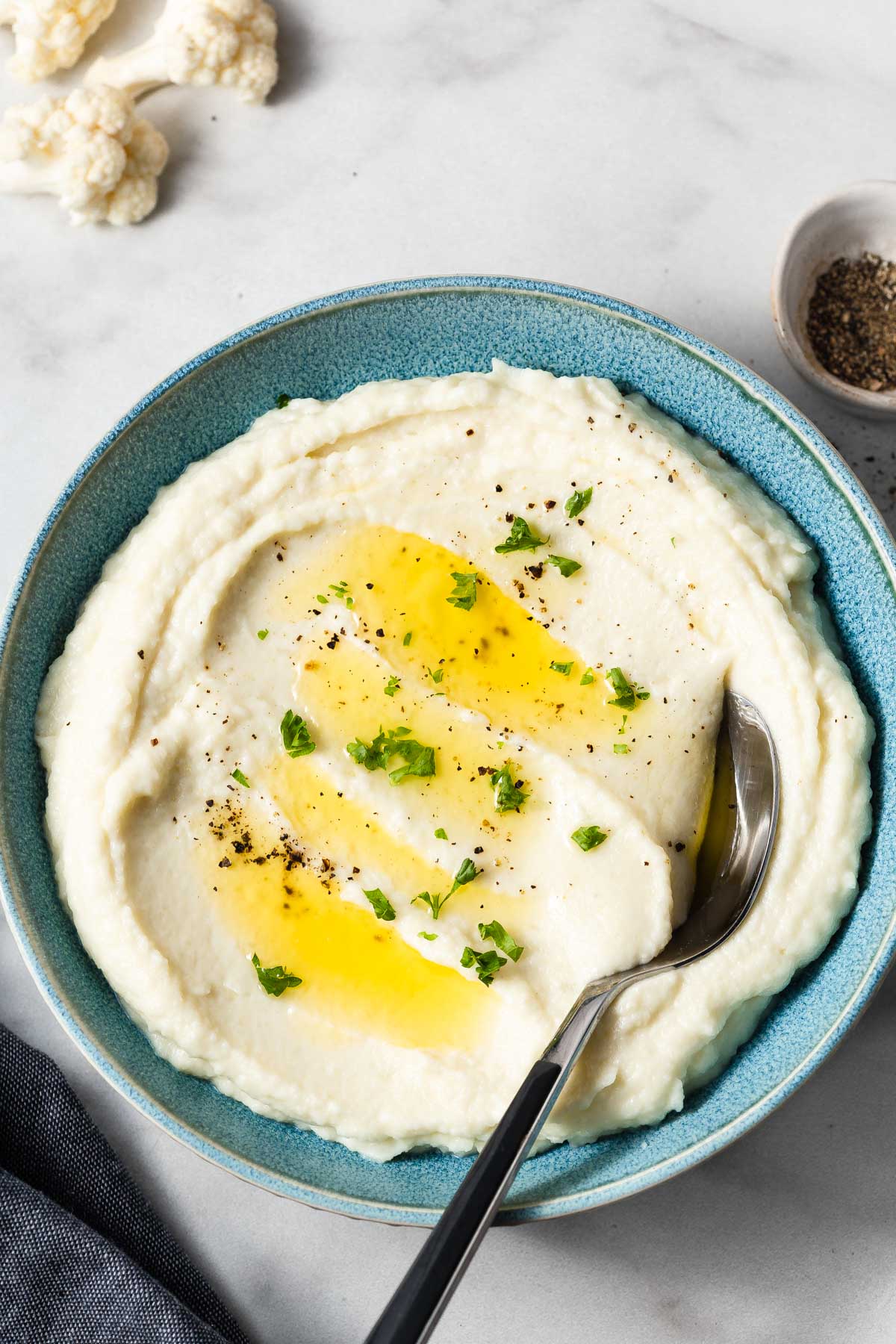 creamy mashed cauliflower in the bowl with a spoon