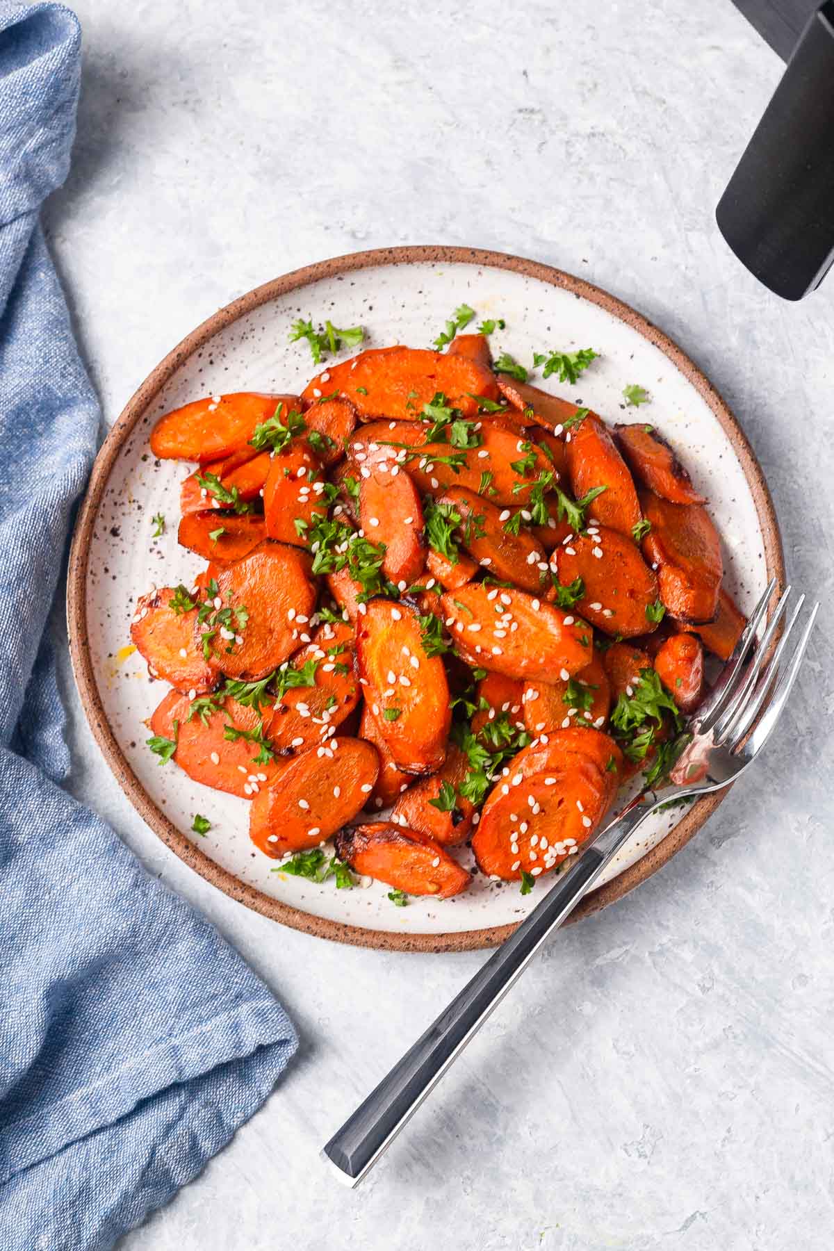 Air fryer roasted carrots in a plate with a fork