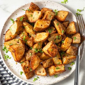 roast potatoes made in the air fryer on a plate with parsley