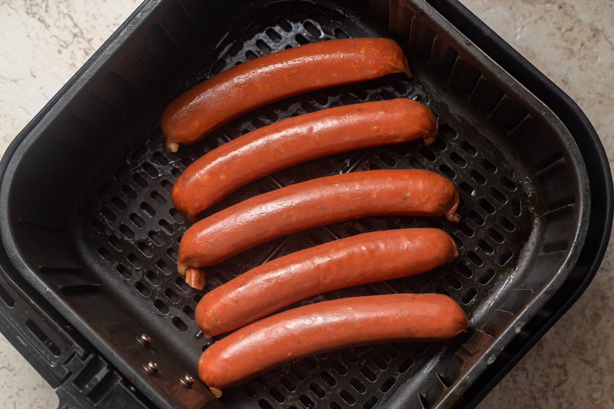 five sausages in the air fryer basket