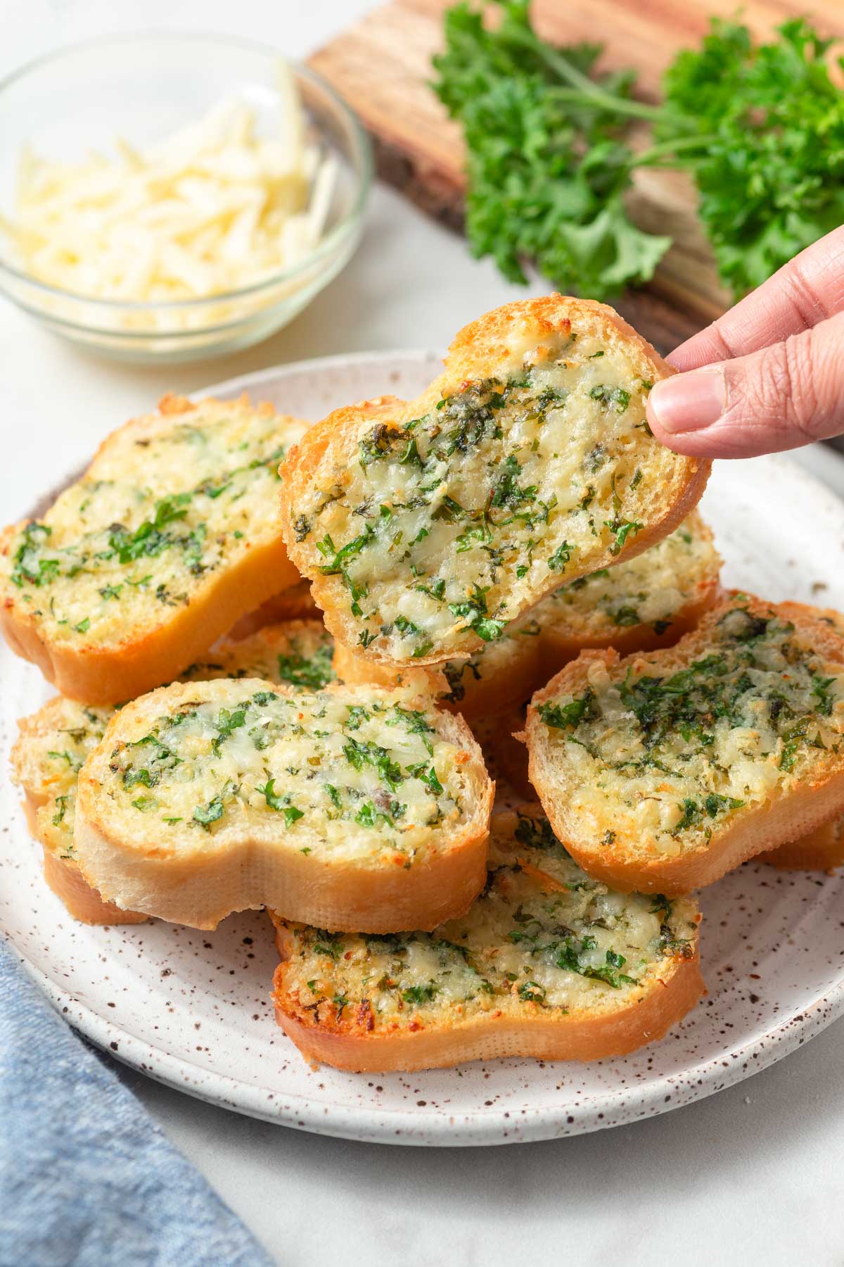 picking up a homemade air fryer garlic bread with cheese.