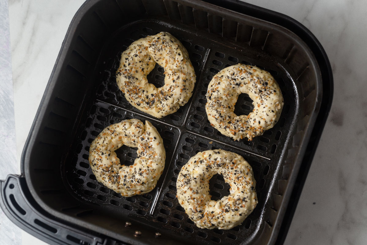 placing the bagels in the air fryer.