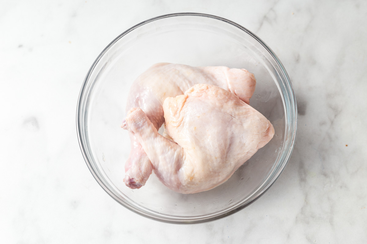 chicken leg quarters in a large bowl.