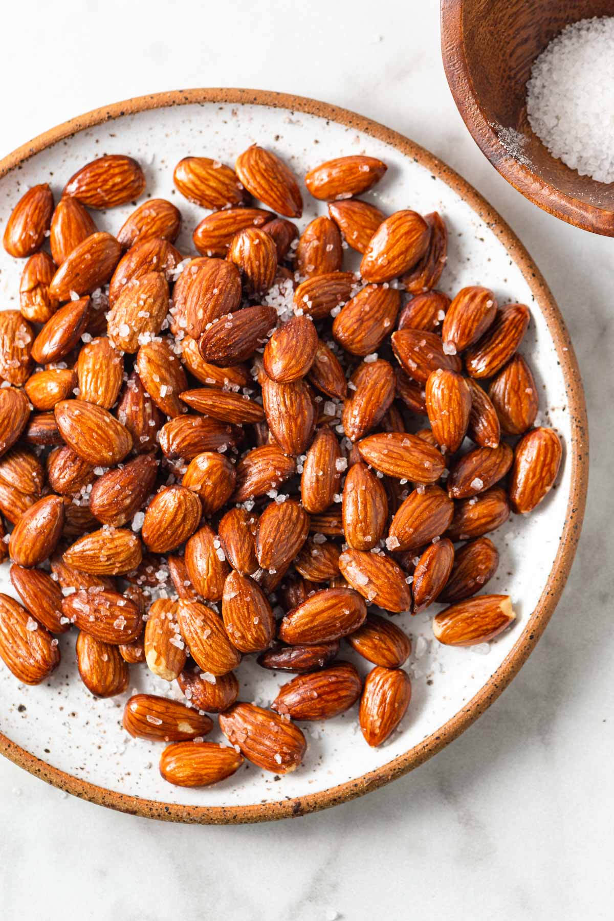 air fryer roasted almonds with sea salt on a plate.