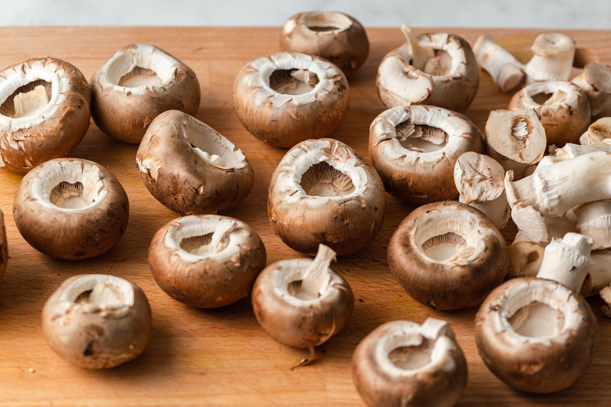 mushrooms with cores removed on a board.