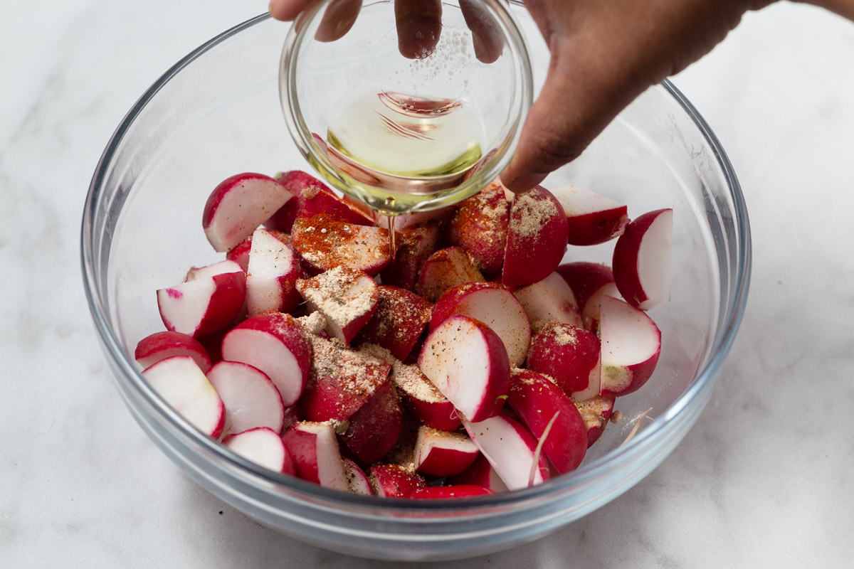adding oil to the radishes.