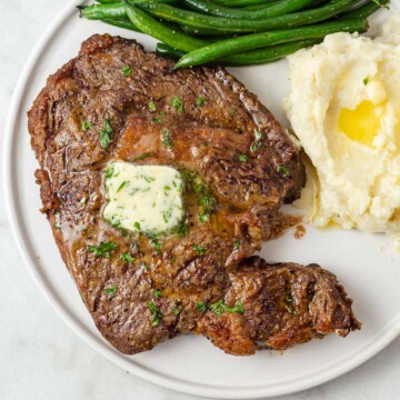 air fryer ribeye steak with green beans and mashed potatoes.