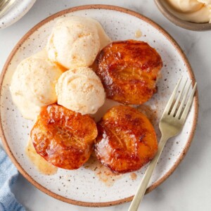 air fryer peaches in a plate with ice cream.