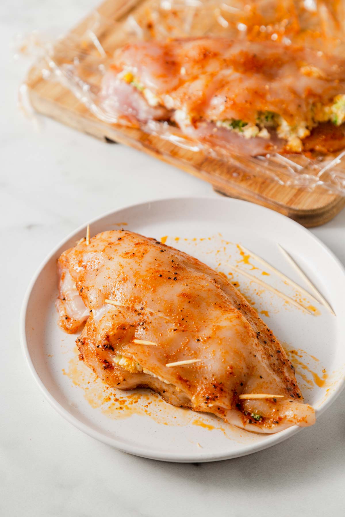 sealing the chicken breast with toothpicks.