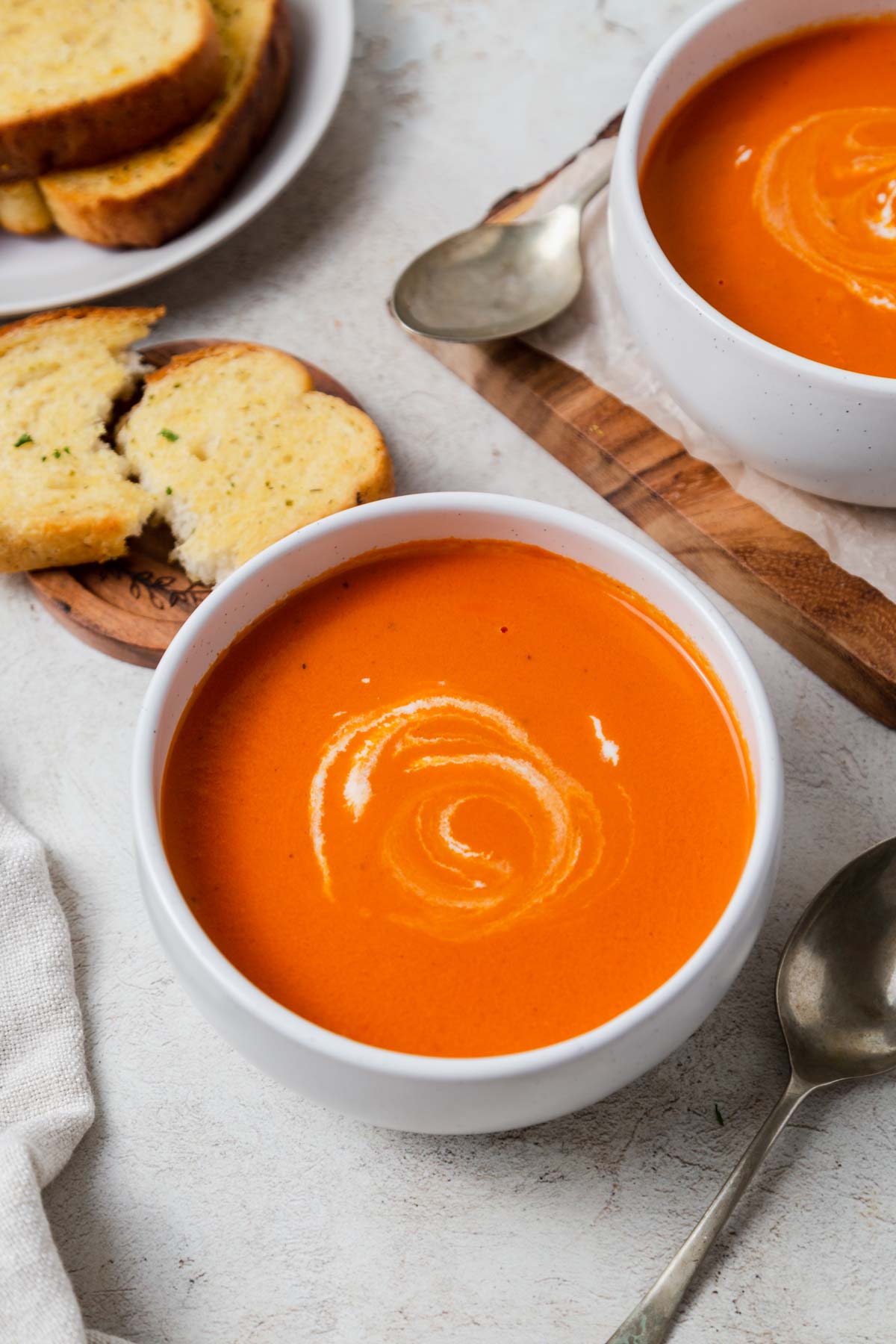 creamy tomato soup with canned tomatoes served with garlic bread