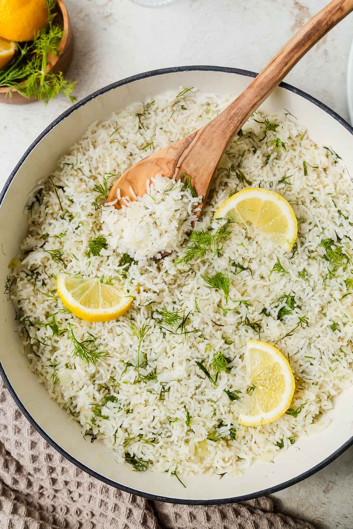 lemon dill rice in a pot with a serving spoon in.