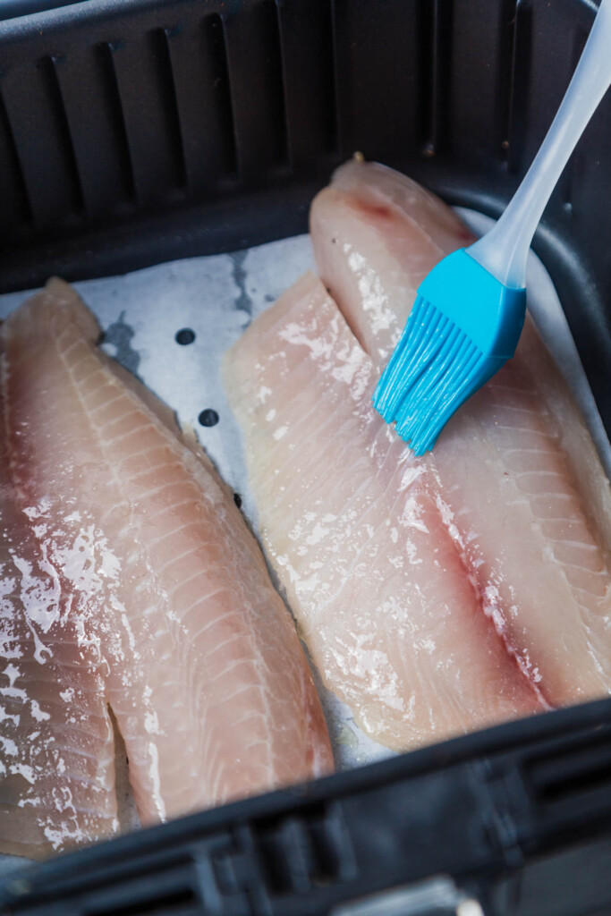 brushing oil on the fillets.