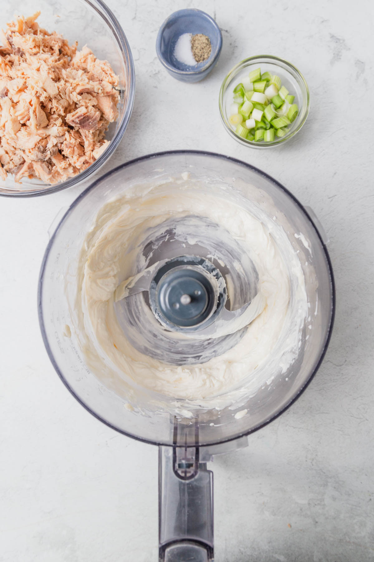 mixing the cream cheese and mayo in a food processor.