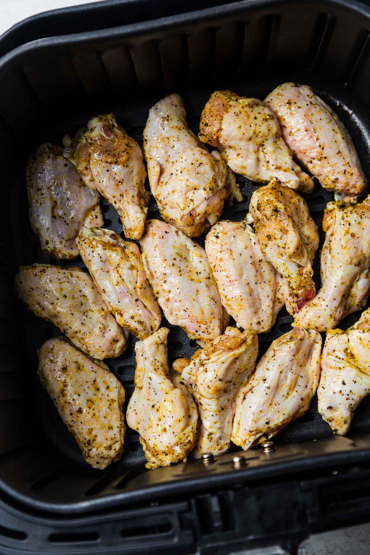 chicken wings in the air fryer basket.