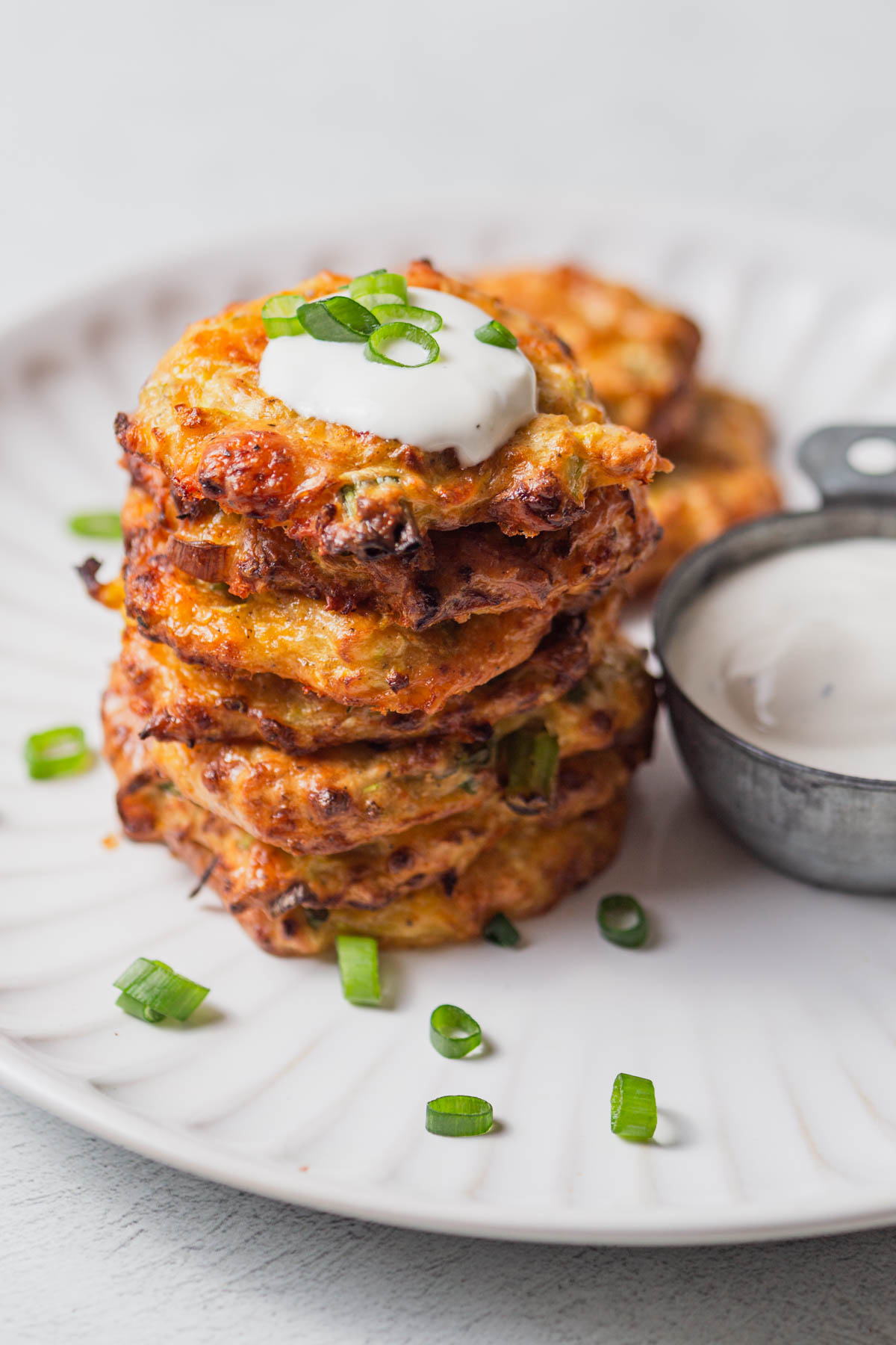 air fryer zucchini fritters with a dollop of sour cream.