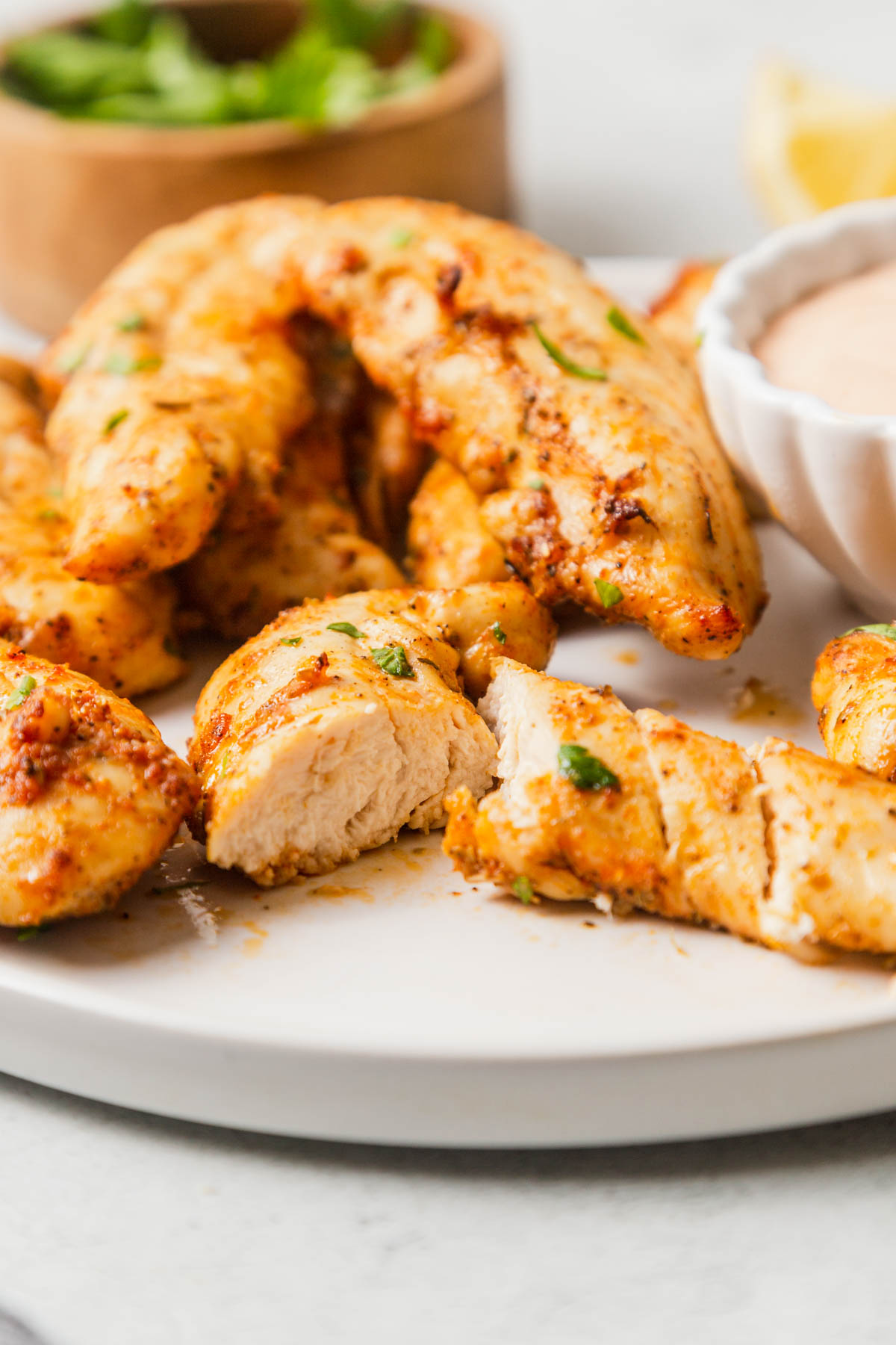 cut up chicken tenders on a plate.