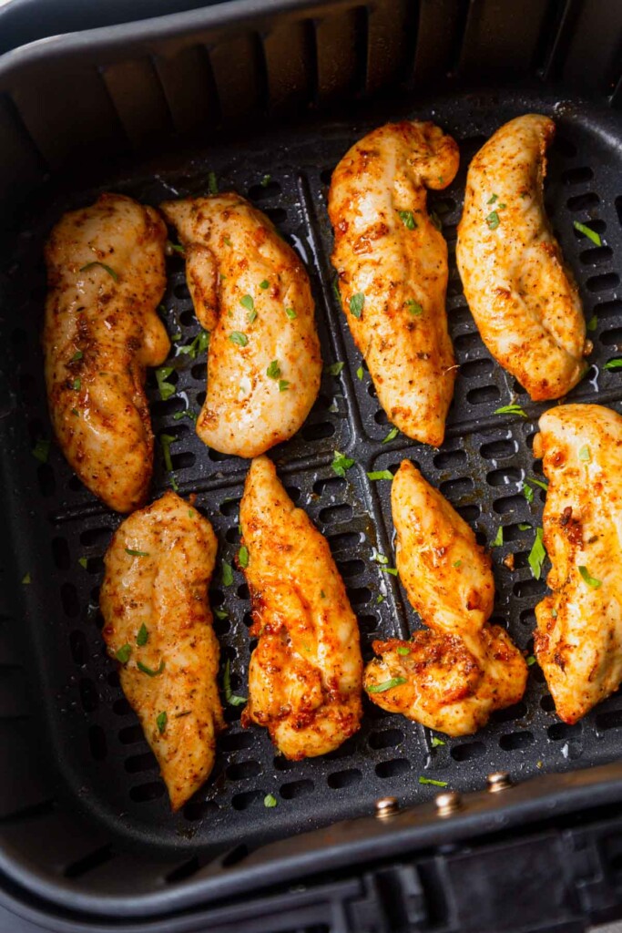 air fried chicken tenders in the air fryer basket.