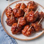 air fryer bbq meatballs on a plate with toothpicks.