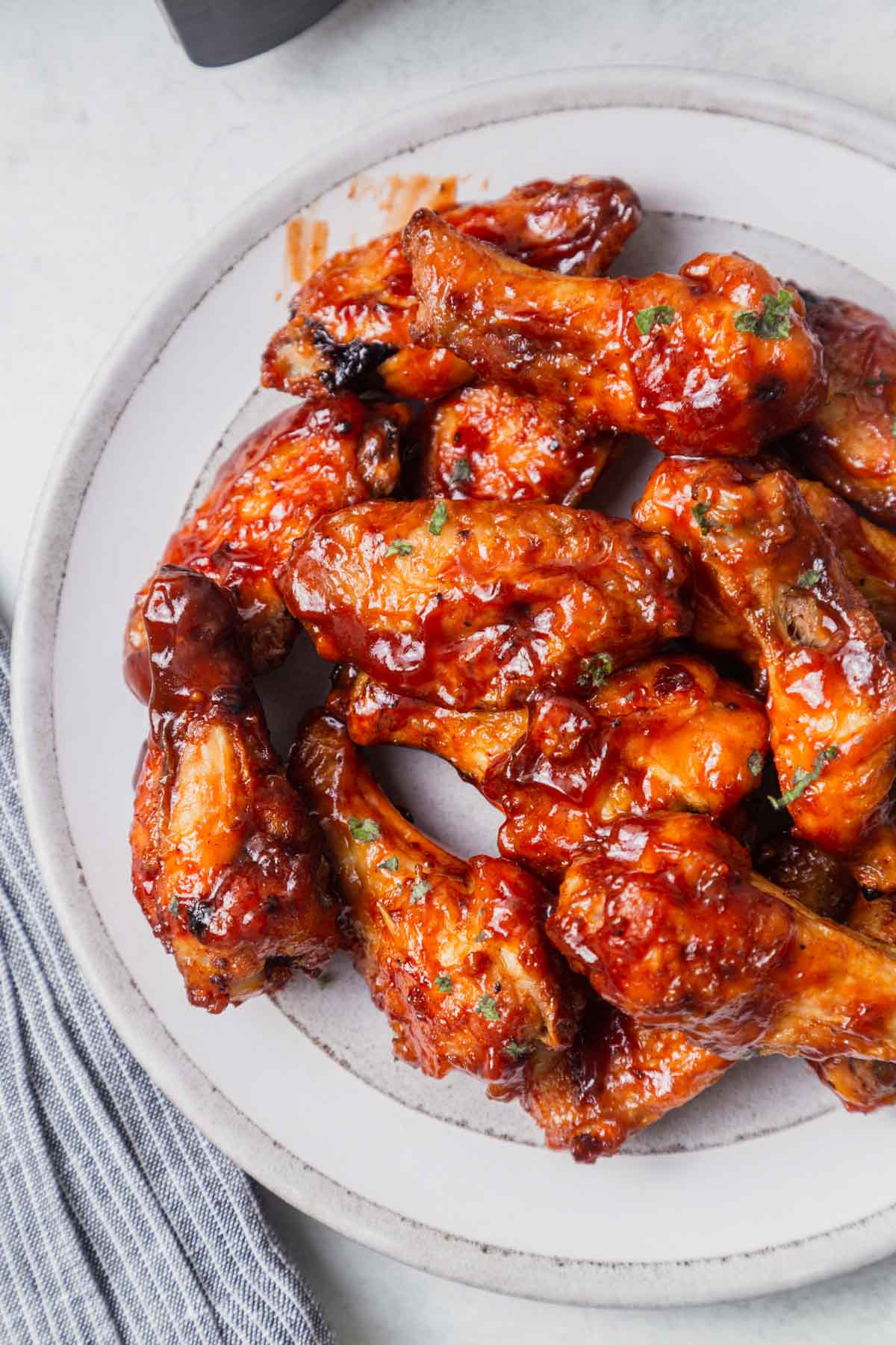 air fryer bbq chicken wings on a white plate.