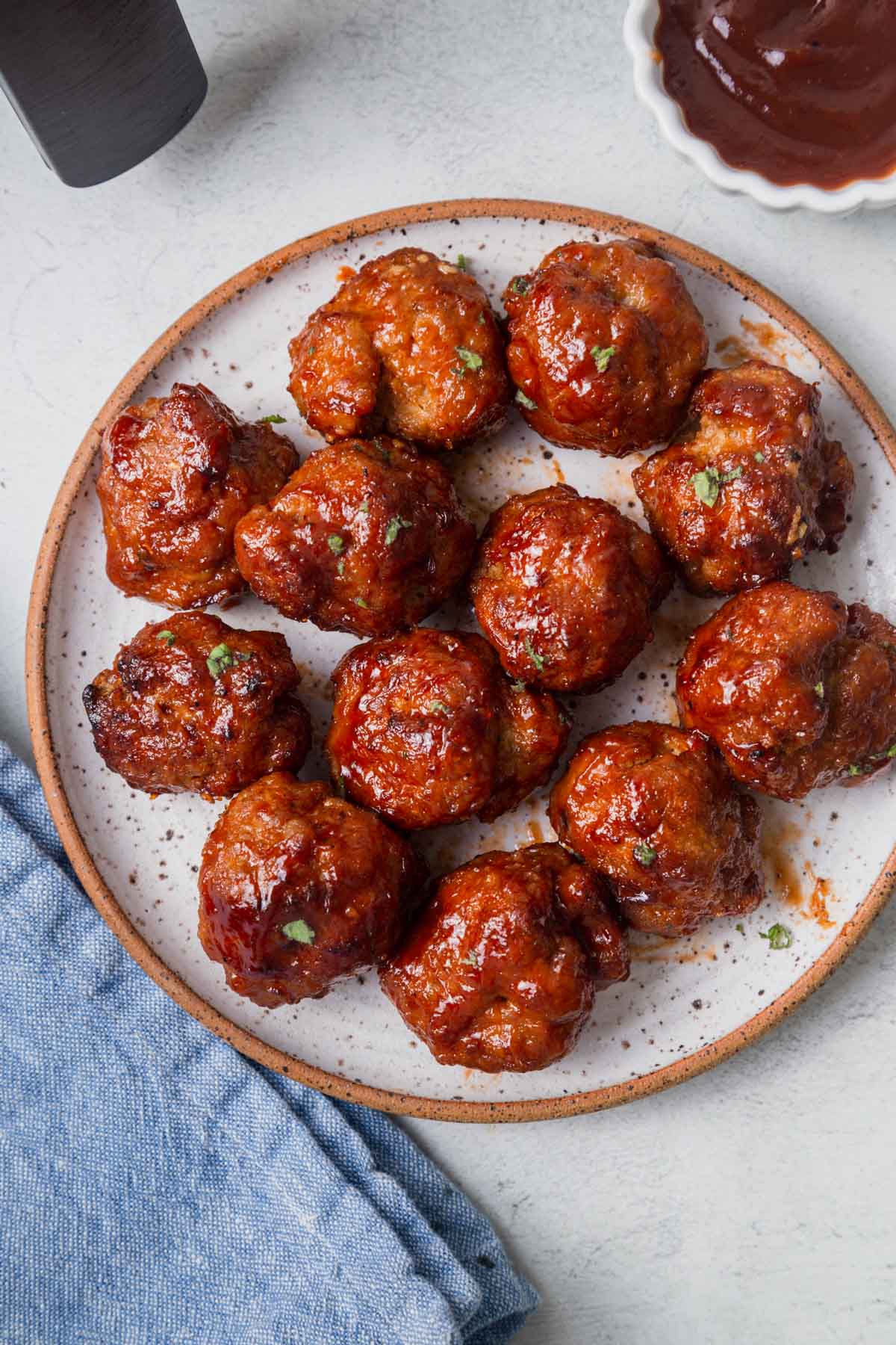 bbq meatballs from the air fryer on a white plate.