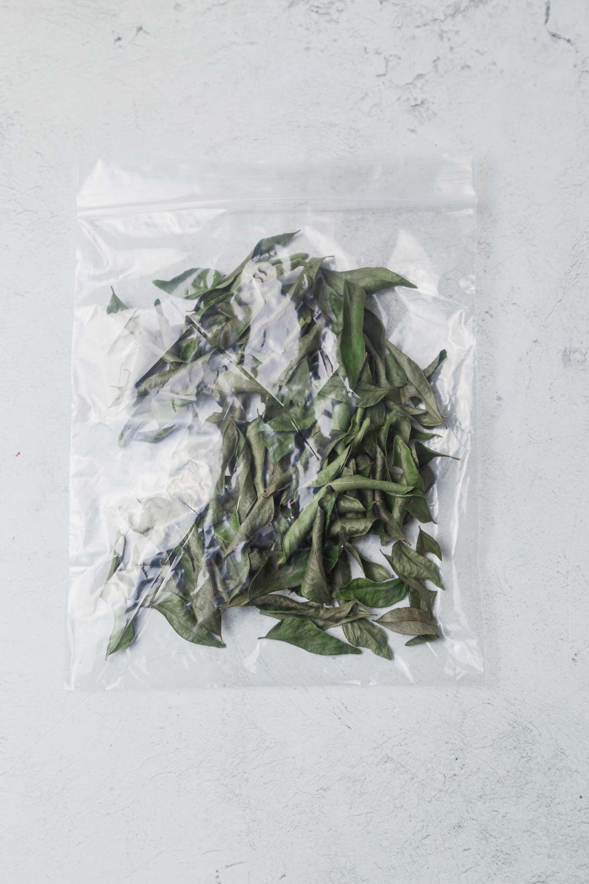 frozen curry leaves in a plastic bag.