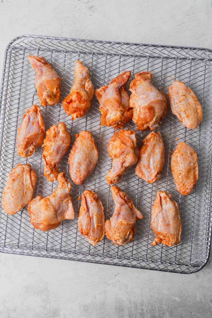 chicken wings on the air fryer tray ready to go into the air fryer.
