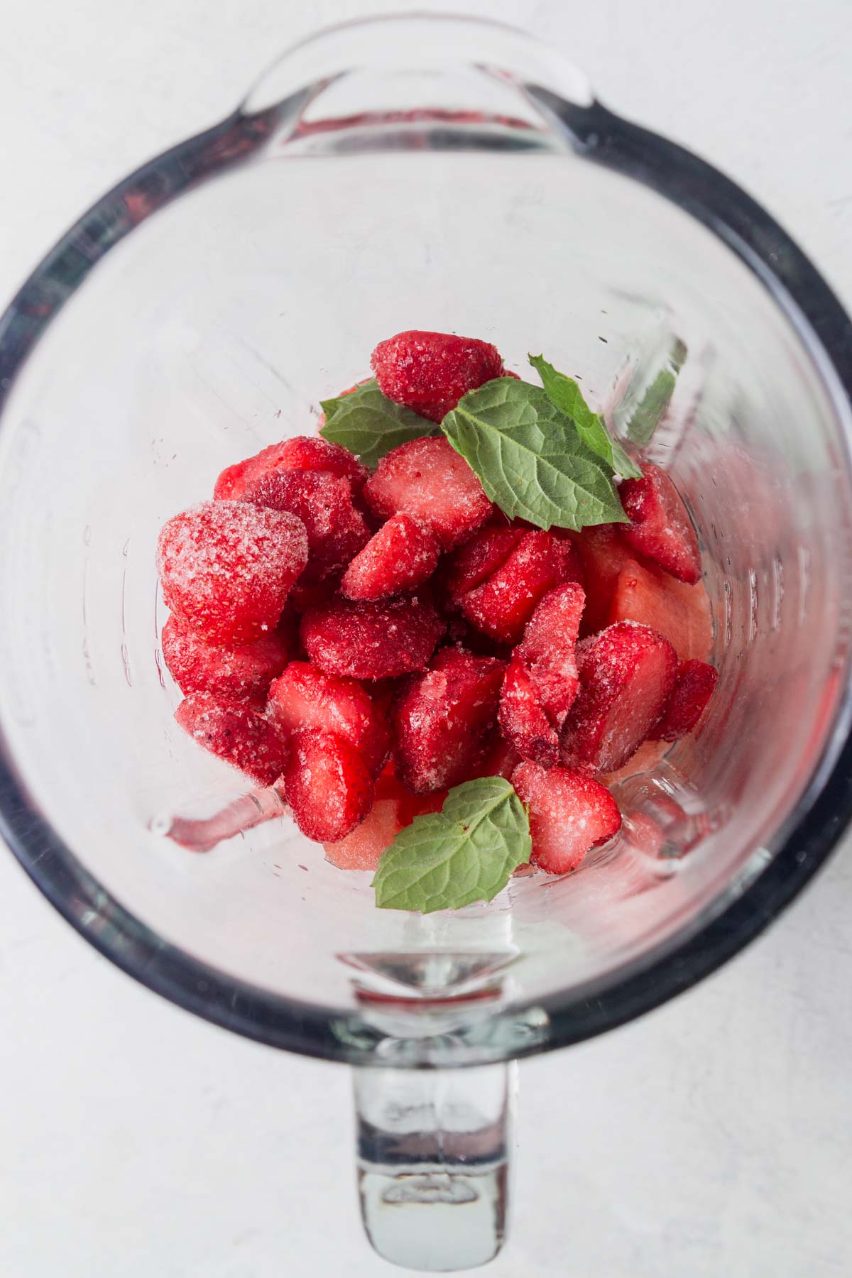 watermelon chunks, frozen strawberries, mint leaves and lime juice in a blender.