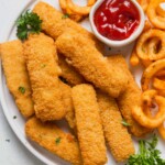 frozen fish sticks cooked in the air fryer and served with curly fries and ketchup.