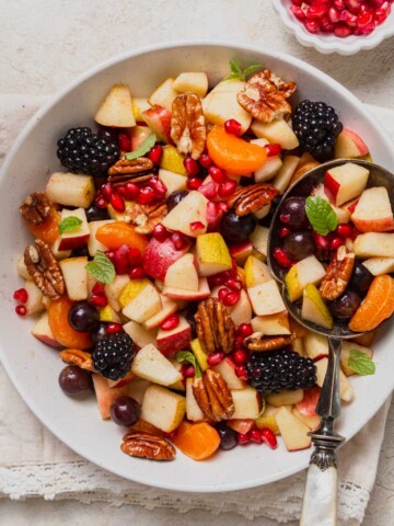 fall fruit salad on a bowl with a spoon.