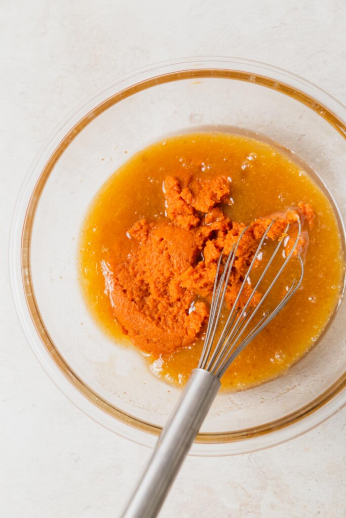 adding pumpkin to the wet batter.