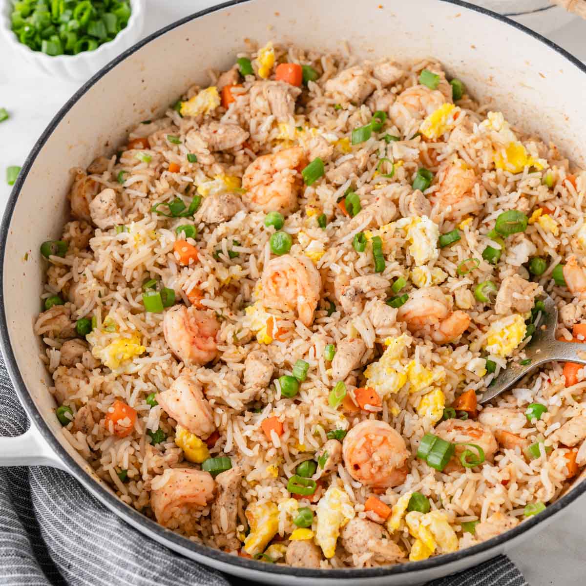 shrimp and chicken fried rice on a skillet.