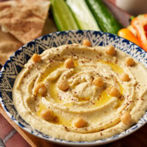 hummus made with canned chickpeas on a blue bowl.