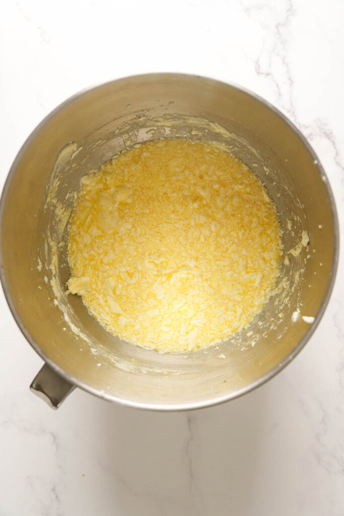 Adding eggs to the batter.