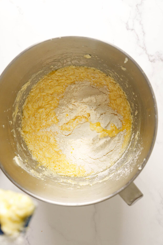 Adding flour to the batter.