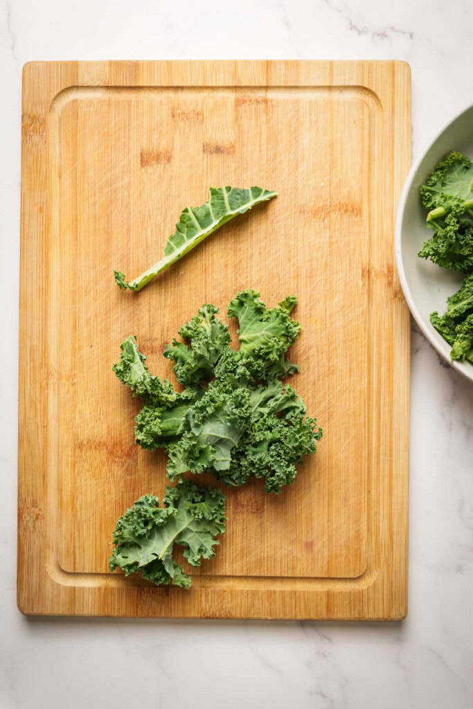 kale leaves on a chopping board.