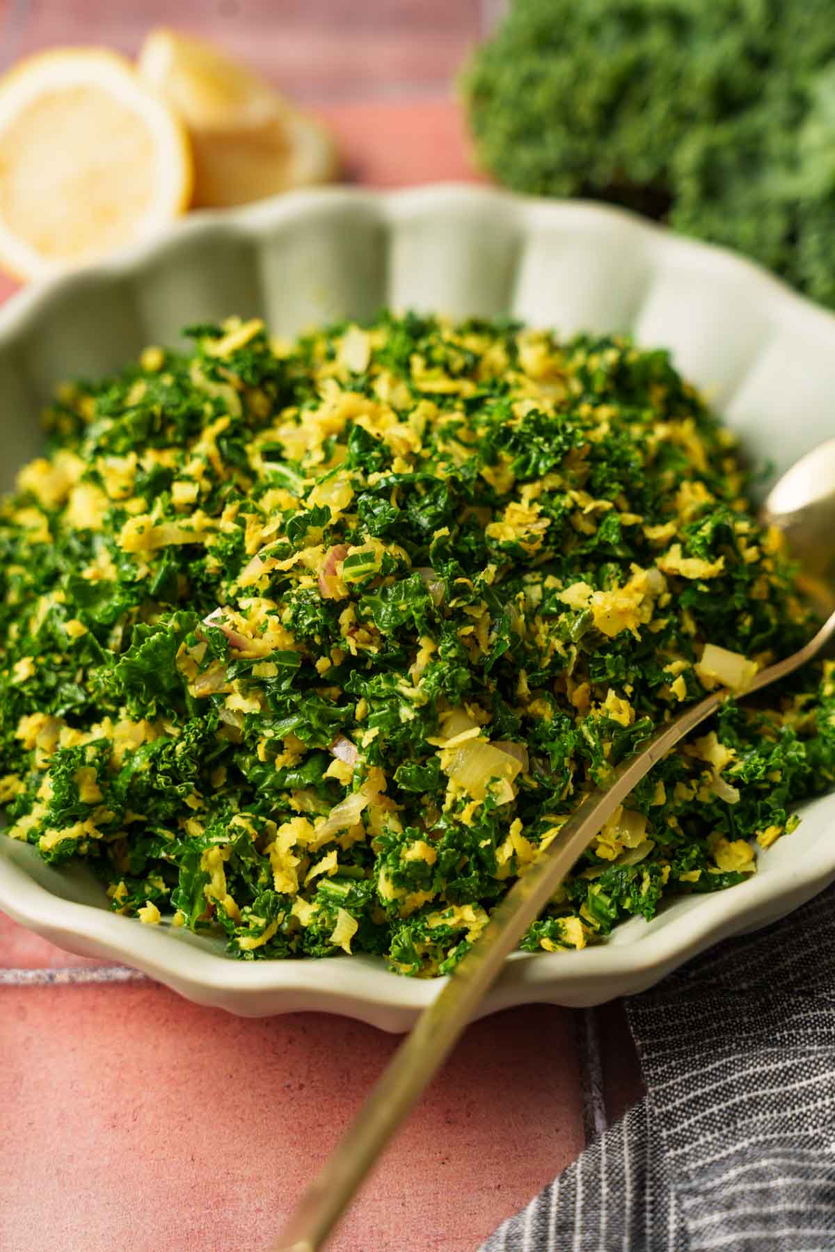 sri lankan sauteed kale on a bowl with a spoon.