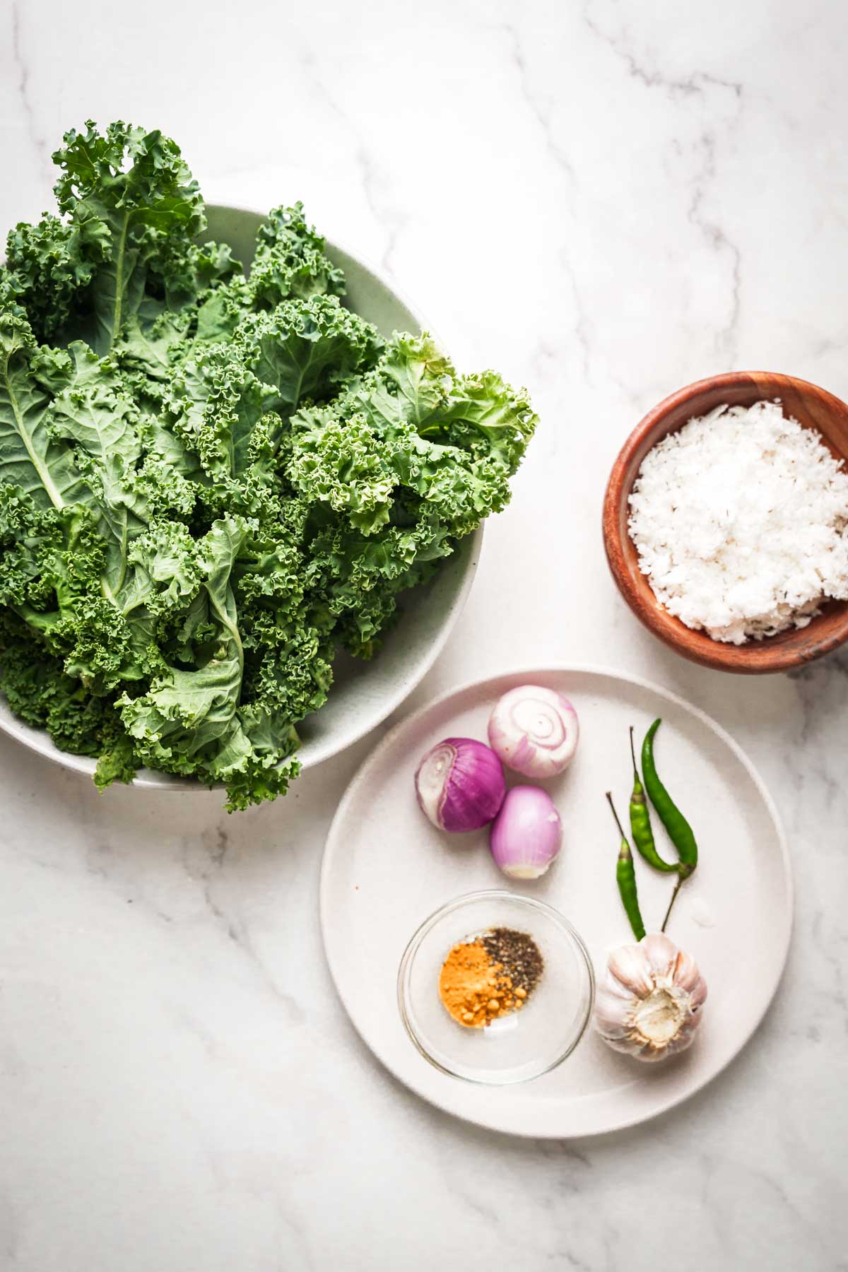 ingredients for sri lankan kale mallum on a white surface.